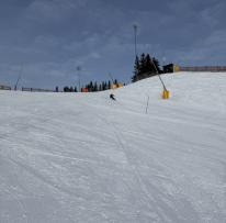 person skis slalom down snowy hill