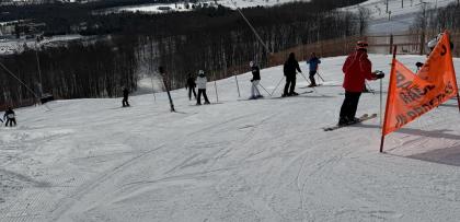 wide shot shows ski hill with people on it