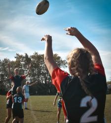 students throwing rugby ball