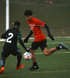 soccer player kicking a ball