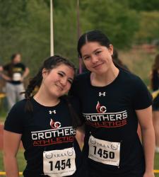 two student track and field team members