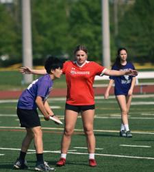 student blocking frisbee throw