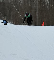 student snowboarding down a hill