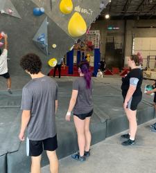 rock climbers climbing with others watching