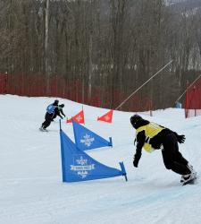 students snowboarding around barriers