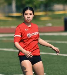 student standing on pitch