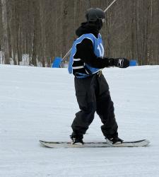 student on a snowboard on level ground