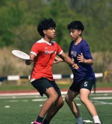 student throwing frisbee