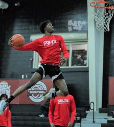 student dunking a basketball