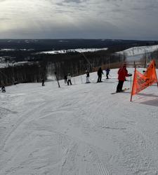 wide shot shows ski hill with people on it