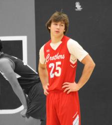 student standing on basketball court