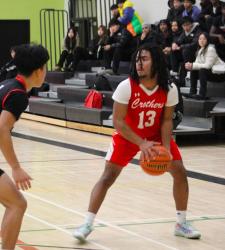 student playing basketball with the ball
