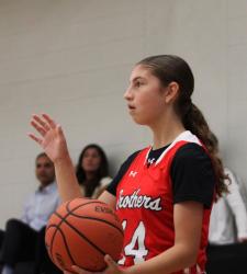 student holding basketball