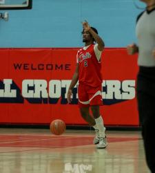 student dribbling a basketball