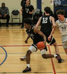 student drippling a basketball