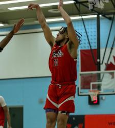 student shooting a basketball