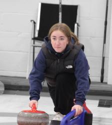 student preparing to throw a rock