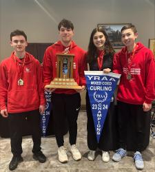 students with trophy and banner