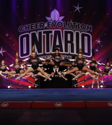 students jumping on cheer stage