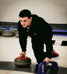 student preparing to throw a rock