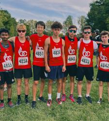 student cross country team standing outside