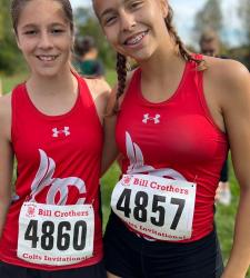 two cross country students standing together