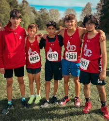 five cross country students standing together