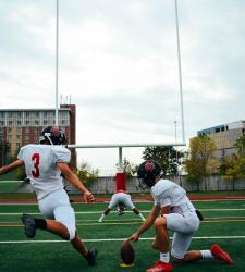 football player kicking a field goal