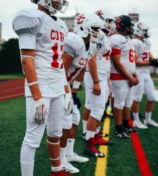 football team members standing on sideline