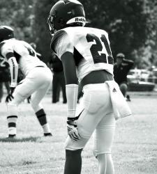 football players on field, black and white