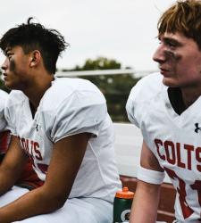 football players sitting on bench