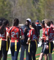 coach talking to flag football players