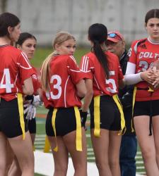 flag football players gathered on sideline