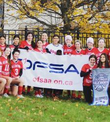 Field hockey team with OFSAA banner