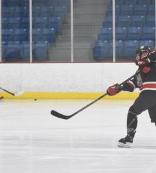 hockey player shooting the puck