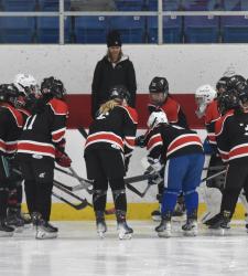 hockey players talking to coach