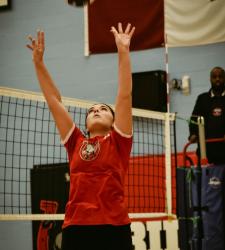 student throwing a volleyball