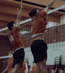 student volleyball players standing close to the net