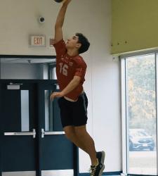 student returning a volleyball