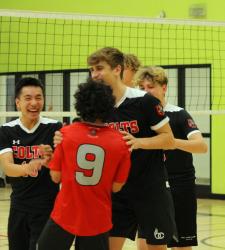 students talking near volleyball net