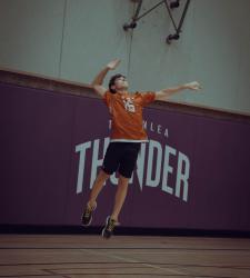 student about to return a volleyball