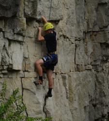 student rock climbing
