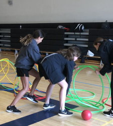 students working on task in gym