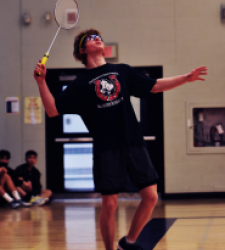 Student serving in badminton